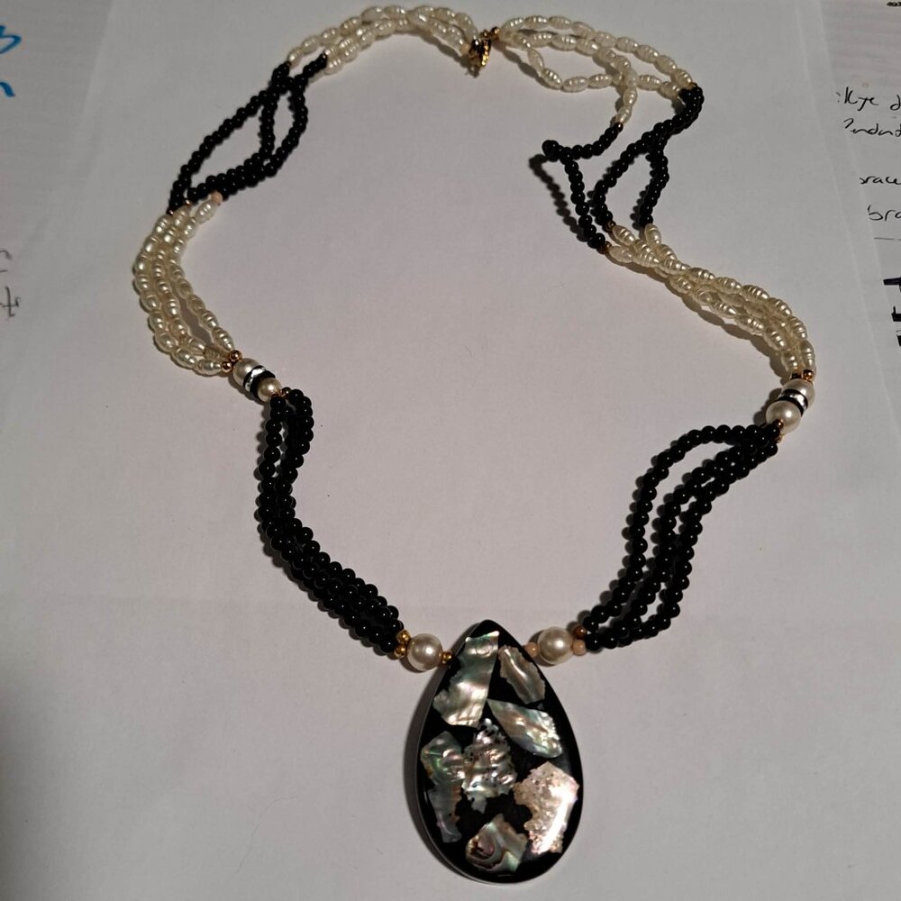 long black and white beaded necklace with pearl like beads and large pendant
